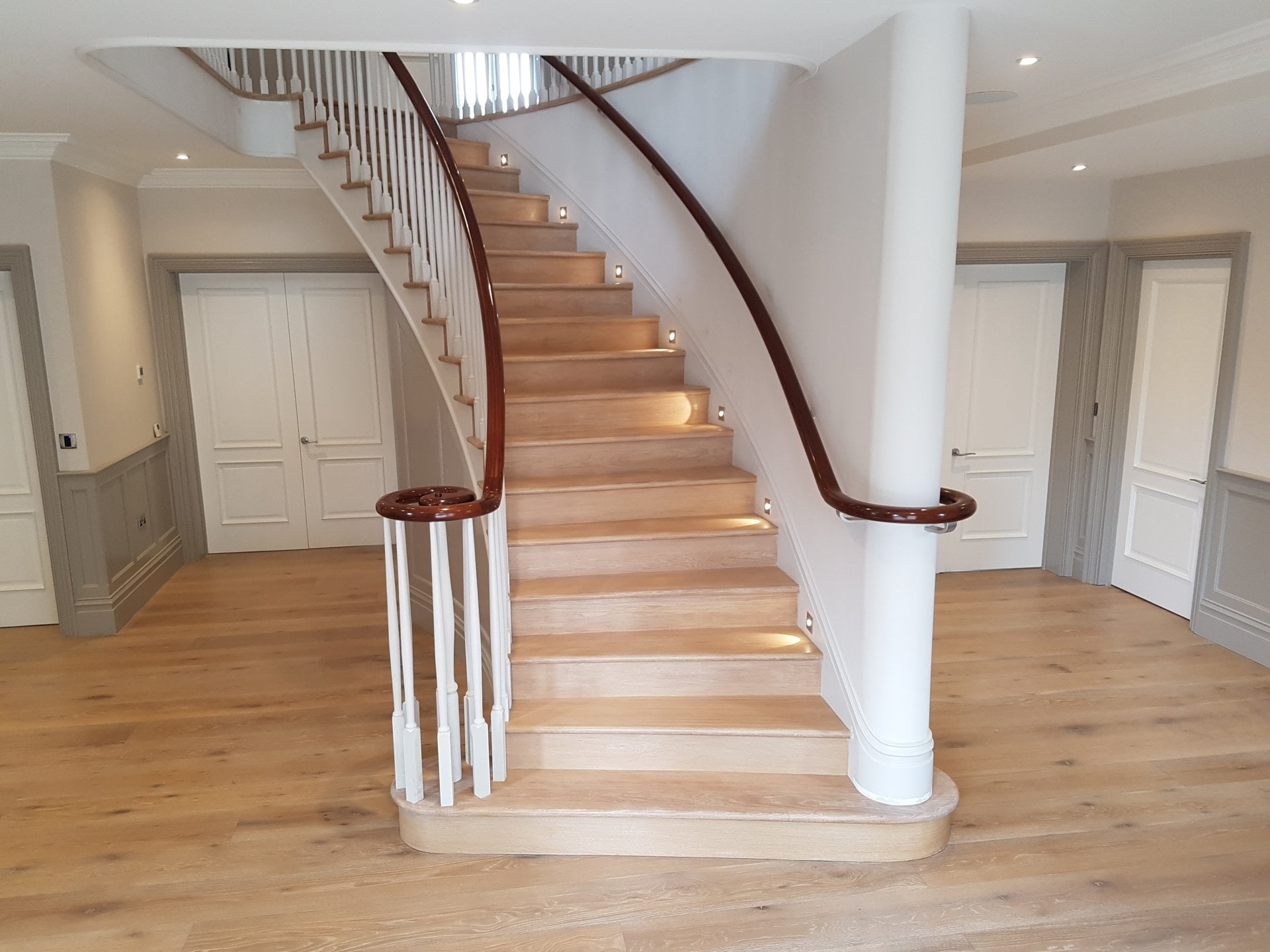 Curved wooden staircase with lights and handrail, white wash floor, paint effect colour match , mahogany french polished handrail
