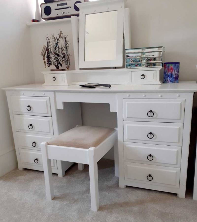 White wooden dresser painted with black drawer knobs